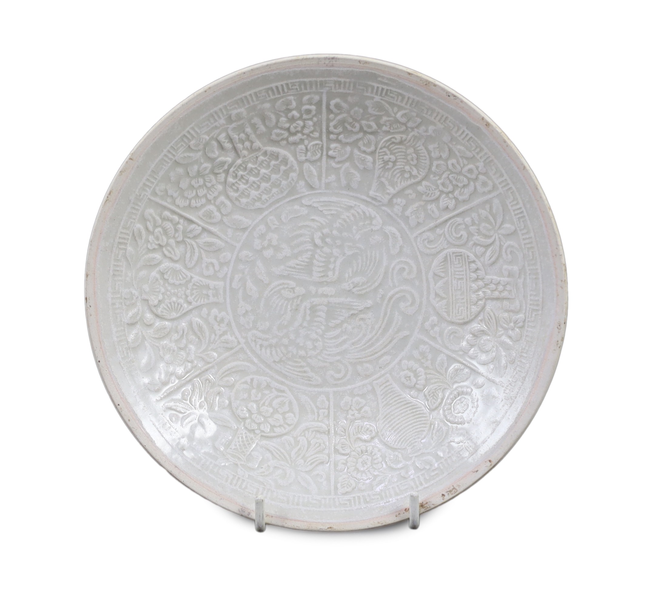 A Chinese Qingbai ‘Phoenix’ moulded dish, Yuan dynasty, 18.2 cm diameter